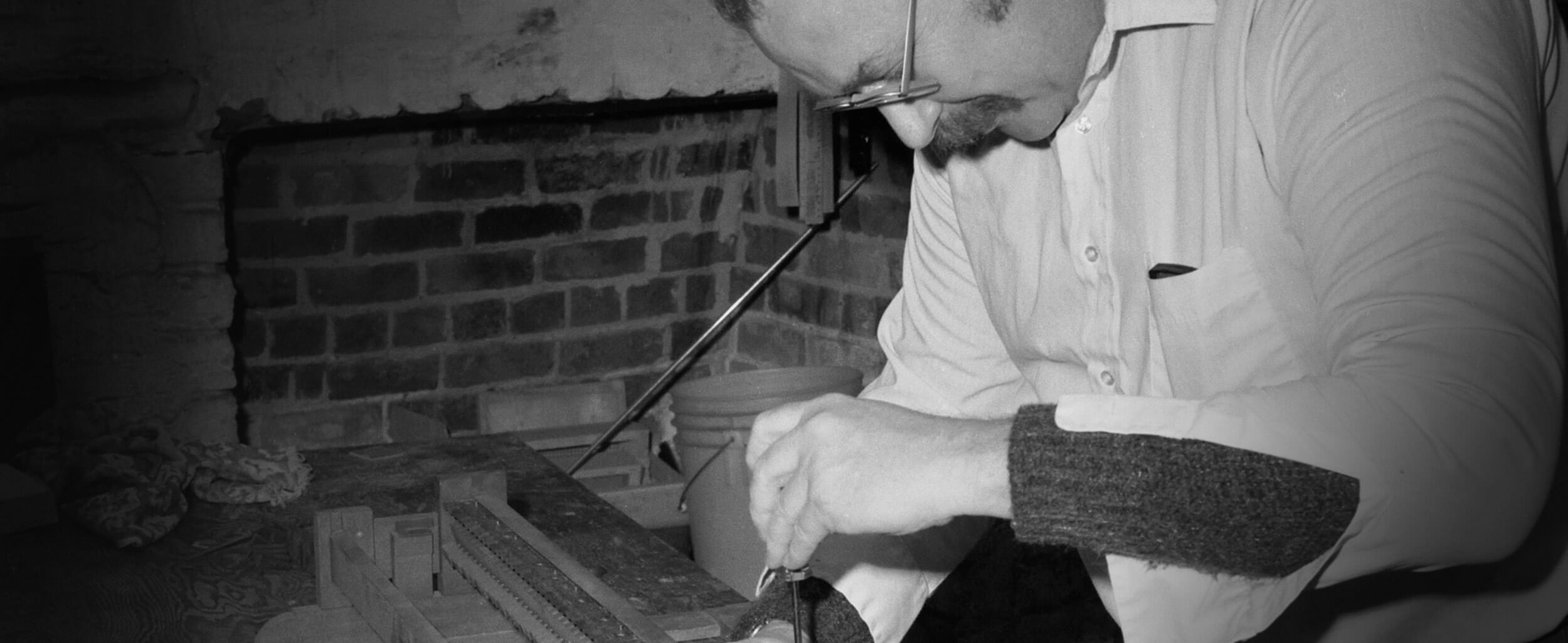 A man is working on something in his hand.