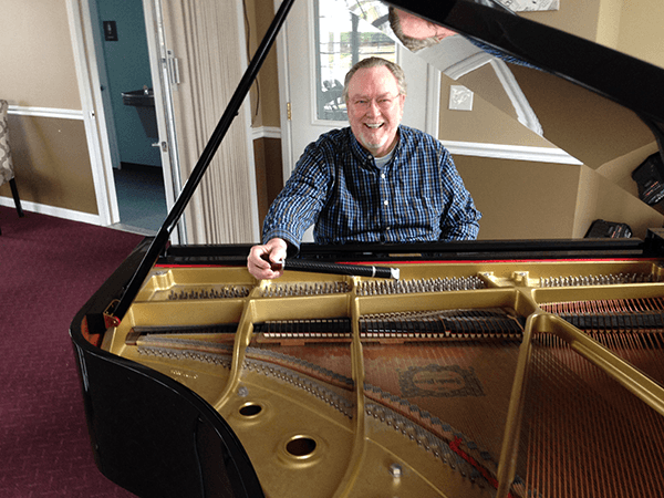 A man sitting at the piano playing an instrument.